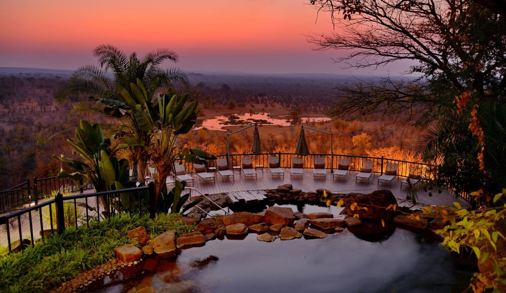 View of the waterhole from the pool area at sunset